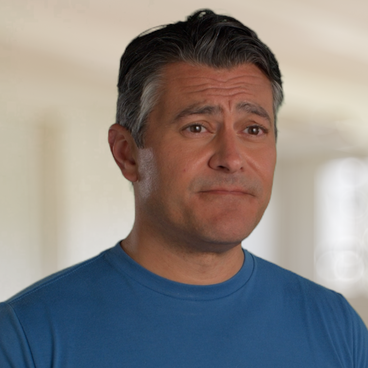 Man with gray hair and beard in a casual setting