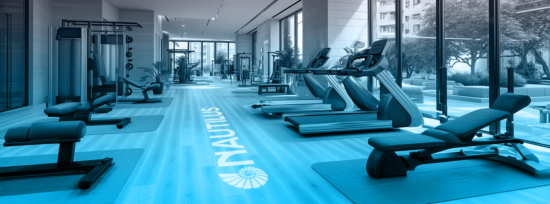 Modern gym interior with equipment and 'Nautilus' branding.